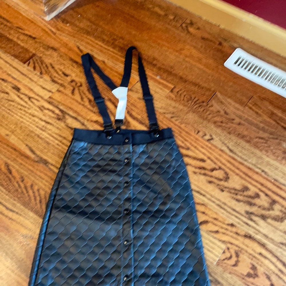 Worn one time faux leather jumper with detachable straps to use as skirt